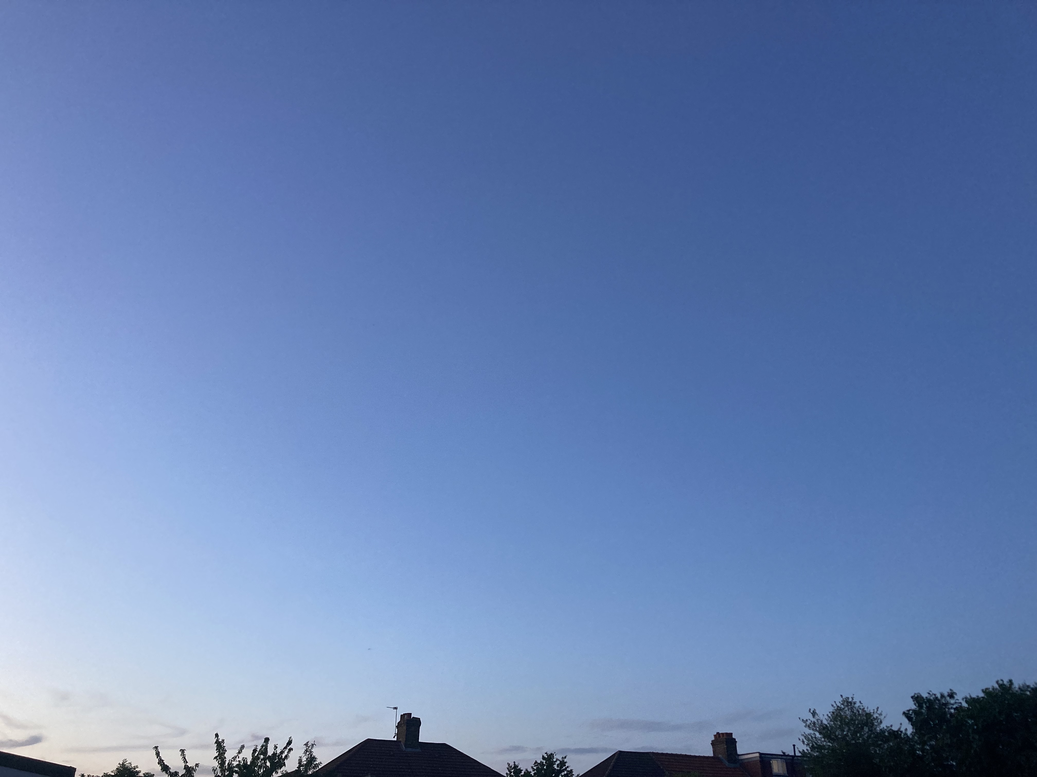 Deep blue dusk sky over rooftops